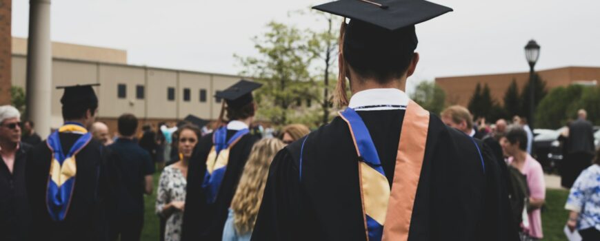 A graduate in an academic gown and cap at a UK graduation