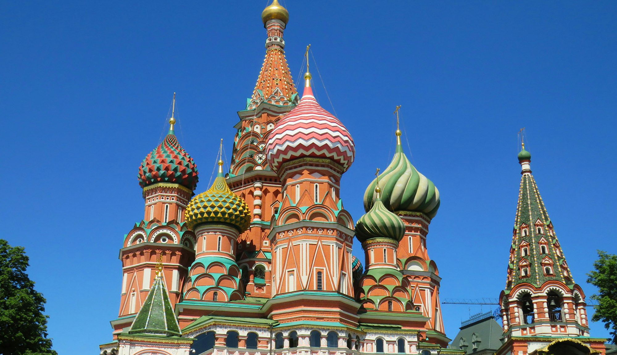 The colourful domes of Saint Basil's Cathedral in Moscow under a blue sky