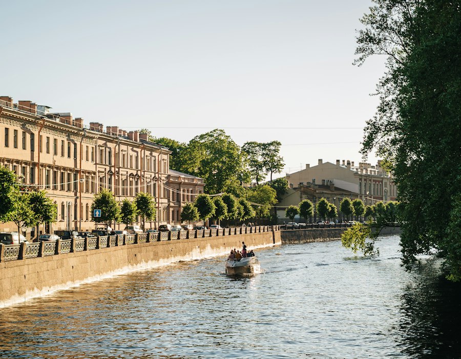 A canal lined with historic buildings in Saint Petersburg in summer