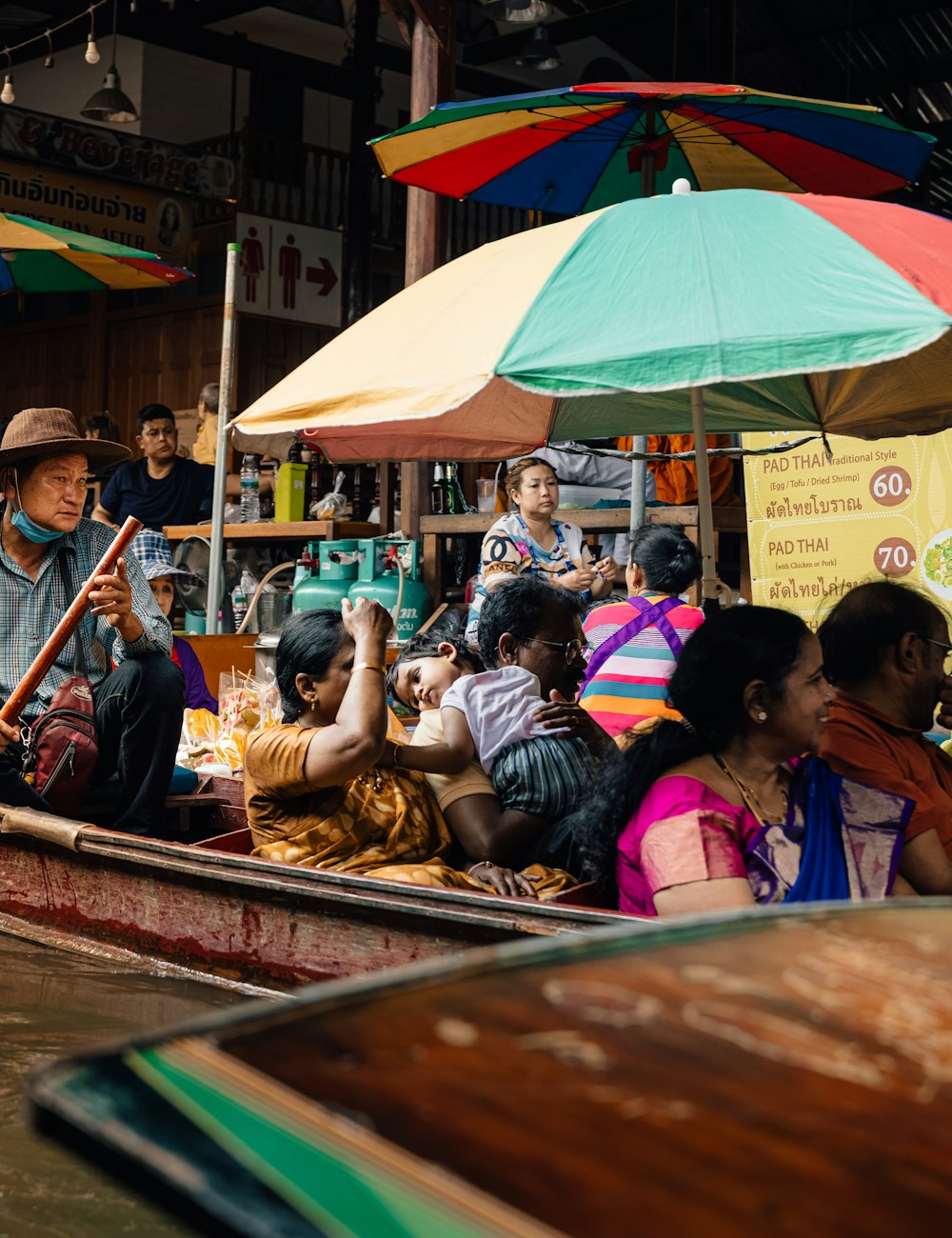 Boats and colourful umbrellas at a floating market in Thailand