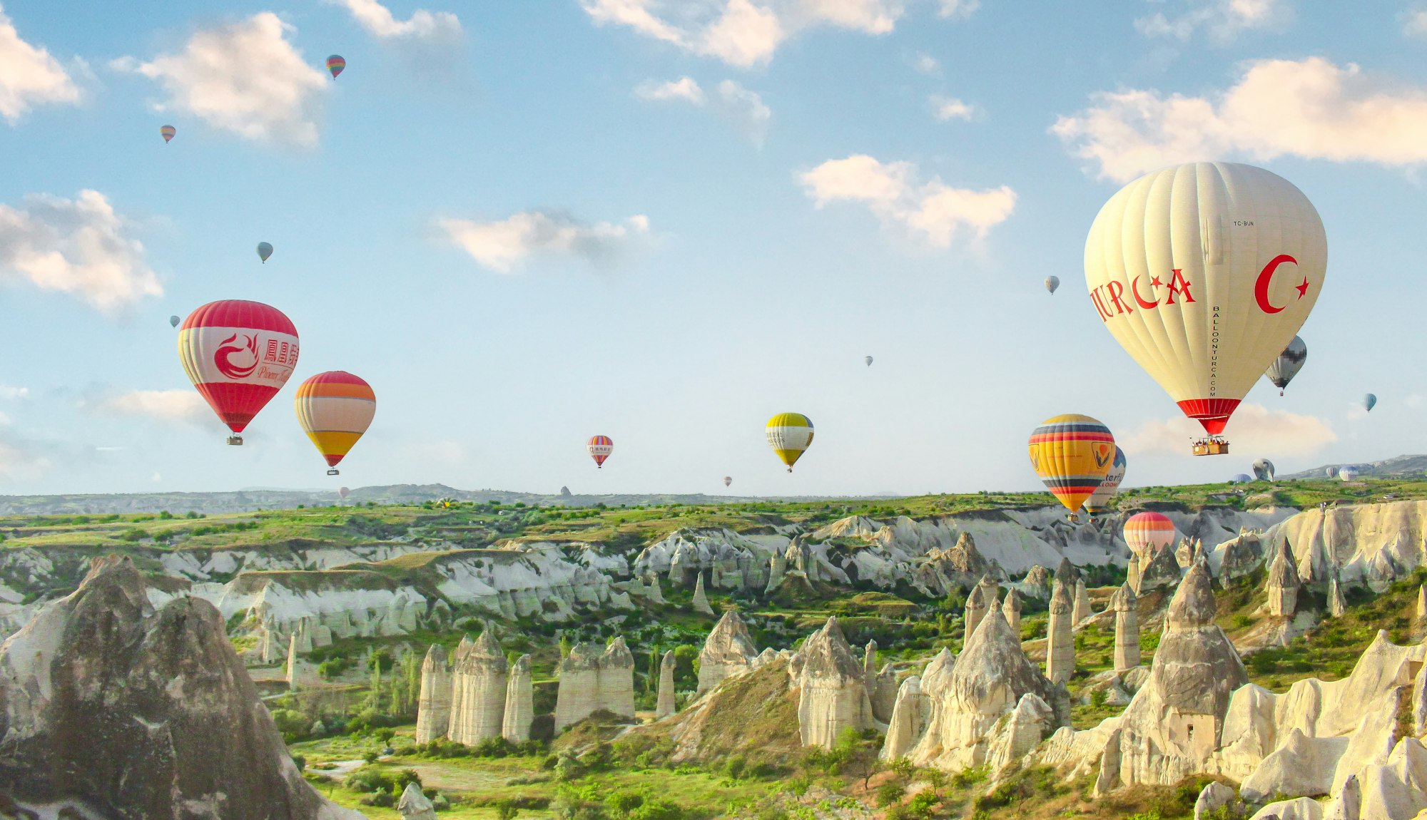 Hot air balloons rising over the valleys of Cappadocia in Turkey