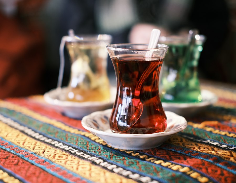 Turkish tea in tulip glasses on a colourful table