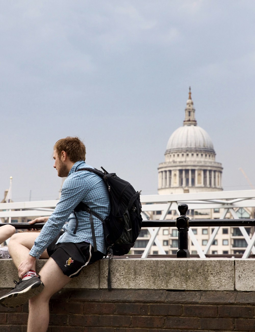 Two students talking on the South Bank with St Paul's Cathedral behind them