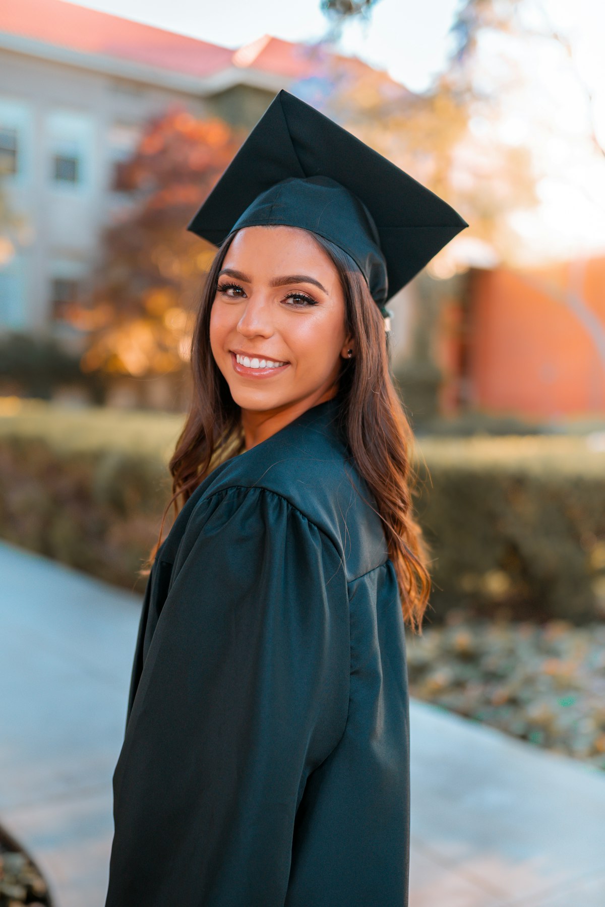 A young woman in a graduation gown, the outcome a genuine student interview is designed to protect