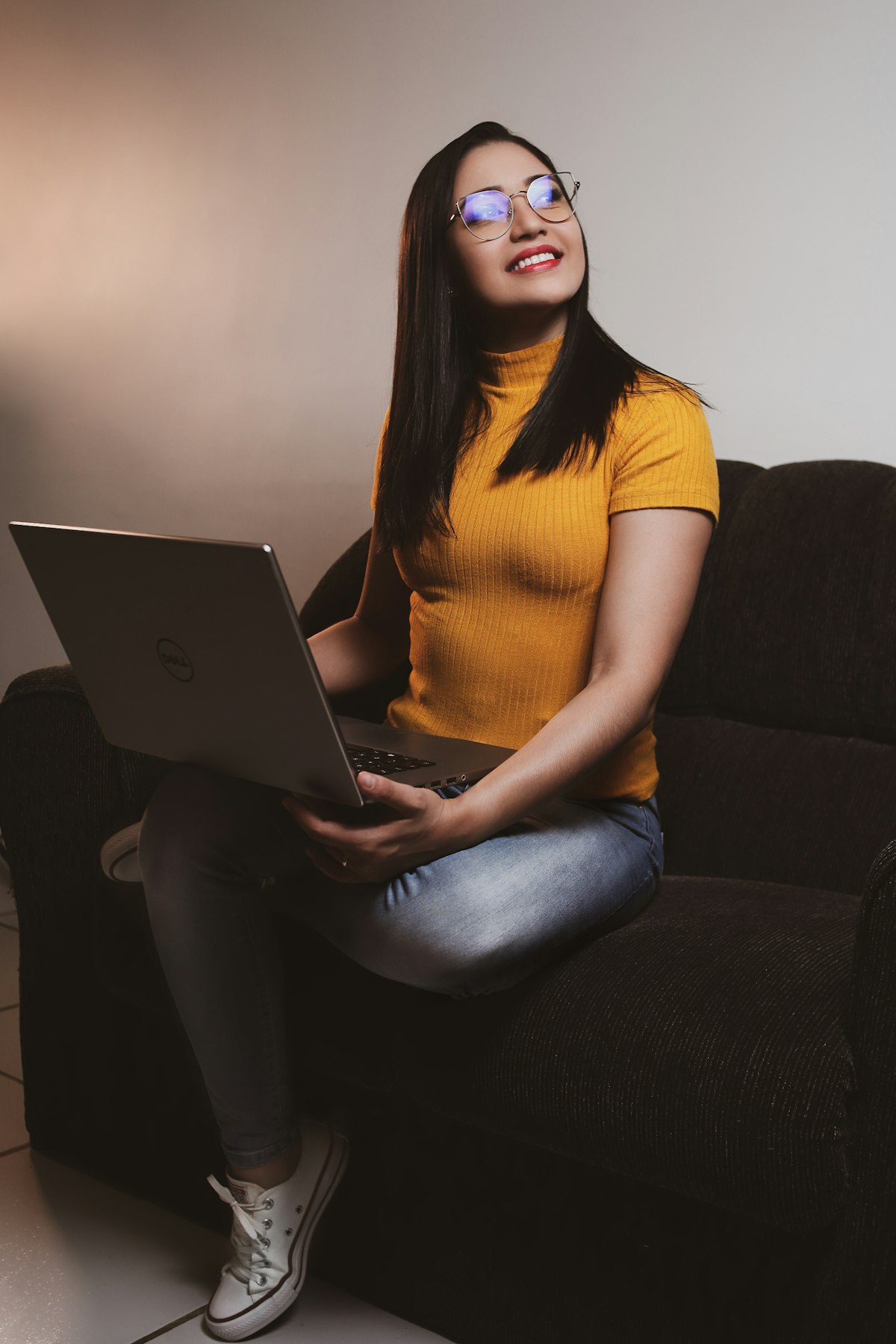 A young woman at a laptop gathering bank statements and letters for a UK visa application